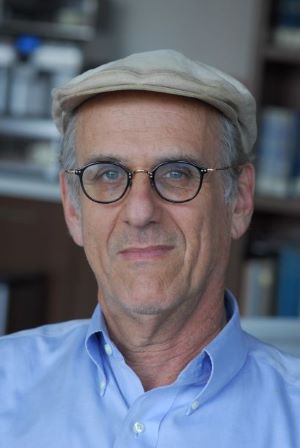 Charles H. Manekin headshot in front of a bookcase